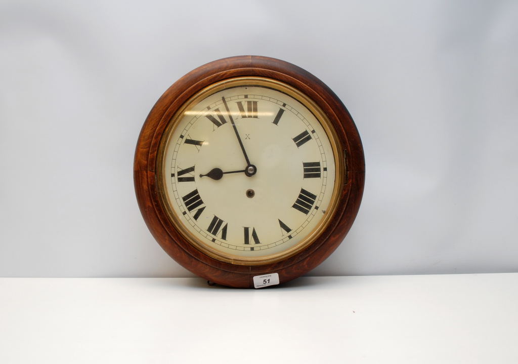 A STAINED HARDWOOD CIRCULAR WALL CLOCK,