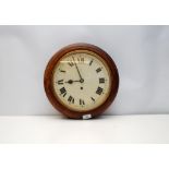 A STAINED HARDWOOD CIRCULAR WALL CLOCK,