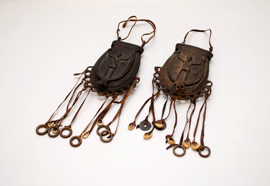 2 AFRICAN MEDICINE MAN BRONZE SPOREN TYPE POCKETS WITH LEATHER TASSELS AND SHELLS