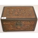 AN ORIENTAL CARVED HARDWOOD BOX FITTED WITH A LIFT OUT TRAY