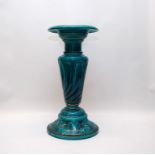 A BRETBY JARDINIERE STAND WITH TURQUOISE GLAZE, THE CIRCULAR TOP ABOVE A GADROONED COLUMN,