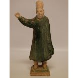 A MING TERRACOTTA FIGURE OF A STANDING MAN WITH A RAISED HAND,