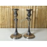 A PAIR OF SILVER CANDLESTICKS WITH HEXAGONAL COLUMNS.