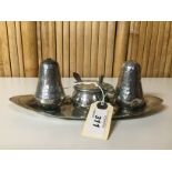 A PEWTER THREE PIECE CONDIMENT SET OF HAMMERED DESIGN ON NAVETTE SHAPED DISH,