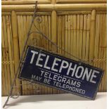 VINTAGE ENAMELLED SIGN "TELEPHONE - TELEGRAMS MAY BE TELEPHONED" MOUNTED IN THE ORIGINAL OLD IRON