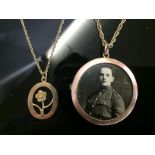 A 9CT GOLD NECKLACE WITH A MILITARY PICTURE LOCKET AND A 9CT GOLD FLOWER PENDANT ON 9CT GOLD CHAIN