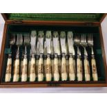 CANTEEN CUTLERY IN IN FITTED MAHOGANY BOX WITH DECORATED HANDLES DEPICTING WILD GAME