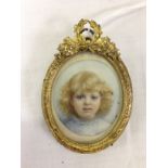 MINIATURE PORTRAIT OF YOUNG GIRL IN BRASS STANDING FRAME