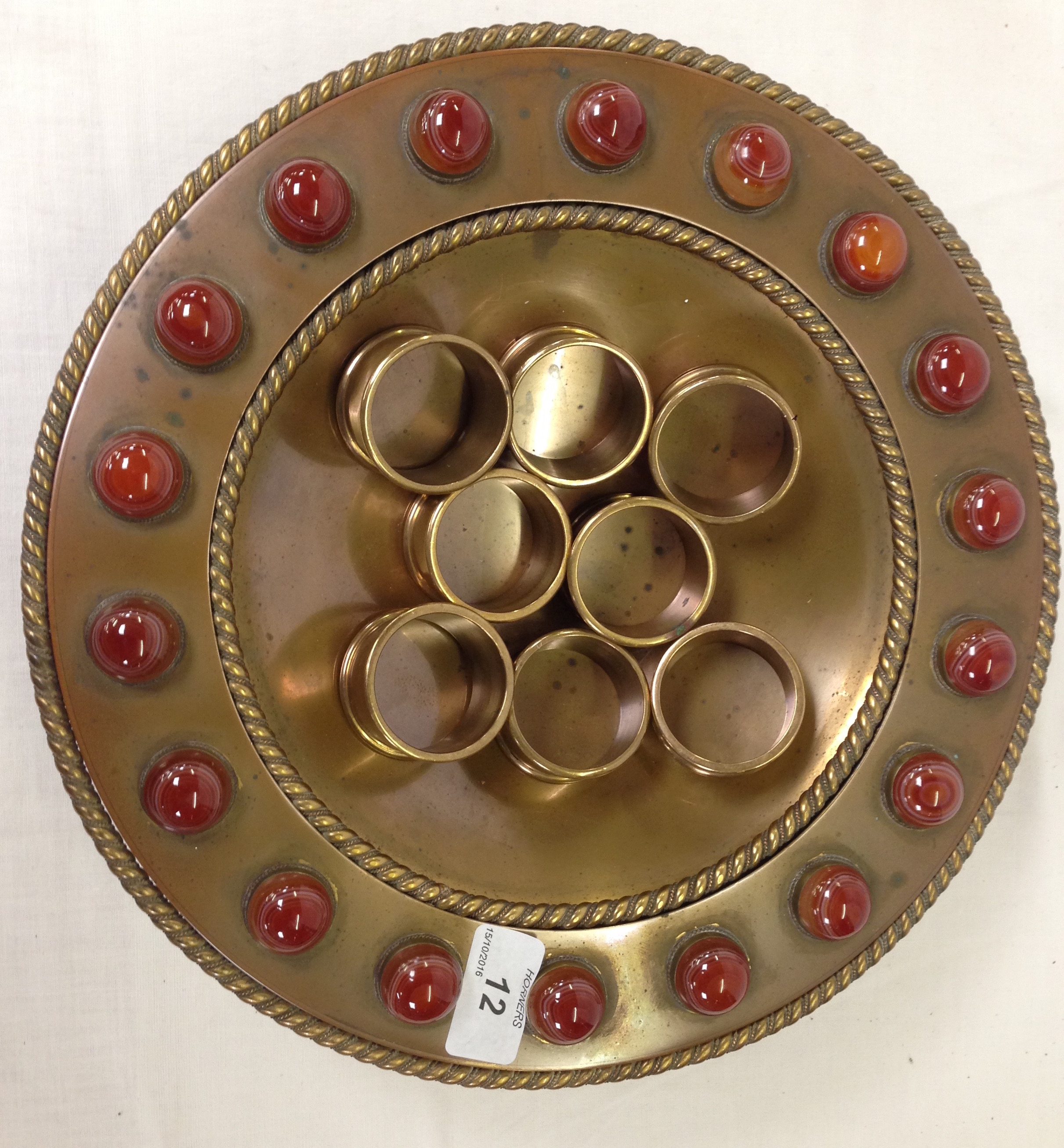 AN ARTS AND CRAFTS COPPER BOWL SET WITH POLISHED ORANGE STONES,