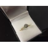 9CT GOLD CLUSTER RING SET WITH DIAMONDS AND WHITE GOLD DECORATION