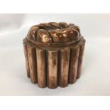 VICTORIAN COPPER CIRCULAR TIN LINED JELLY MOULD WITH FLUTED EDGE AND TWISTED ROPE TOP STAMPED WITH