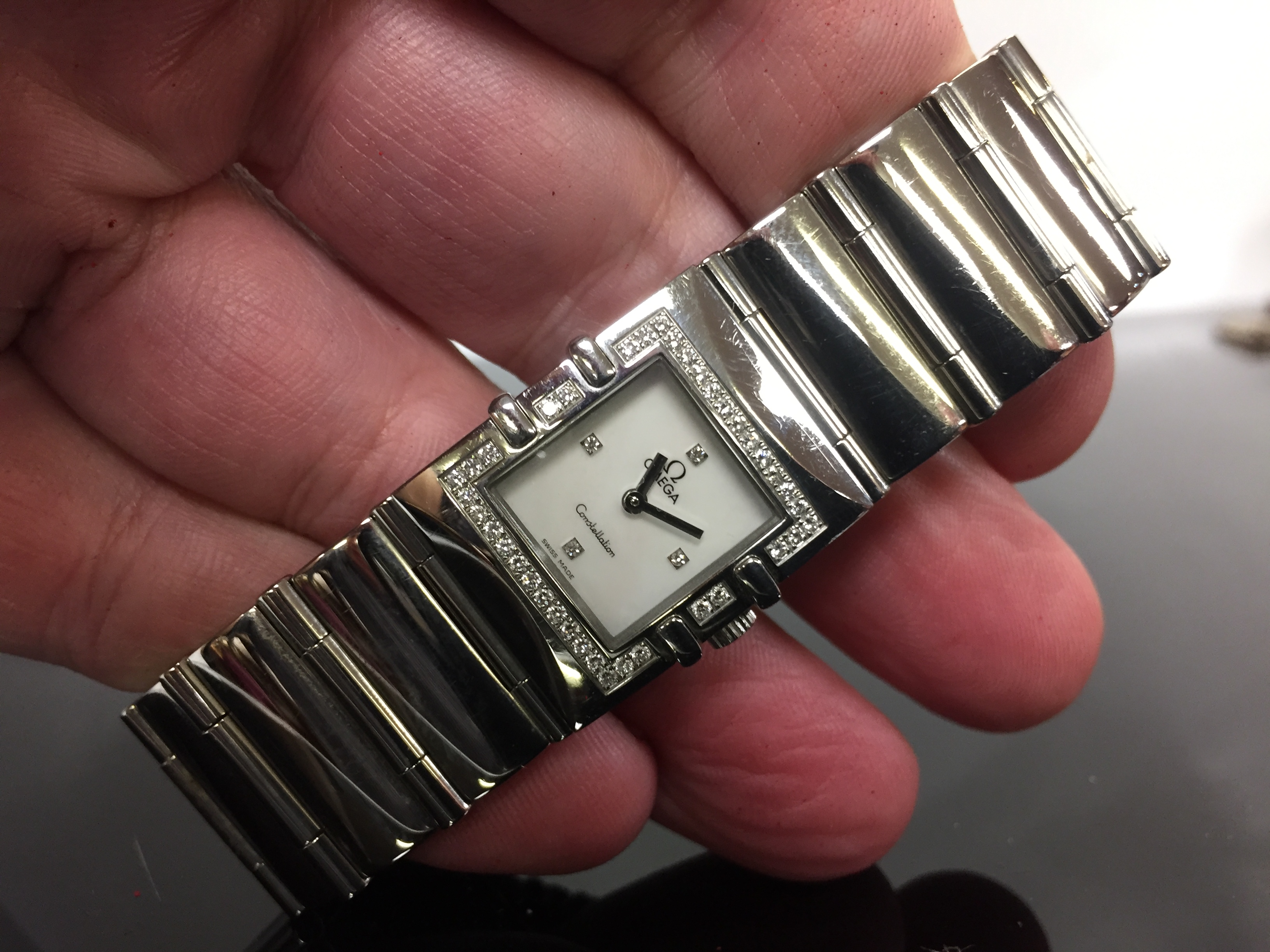 A LADY'S OMEGA CONSTELLATION WITH MOTHER OF PEARL FACE, DIAMOND DOT DIAL AND DIAMOND BEZEL,