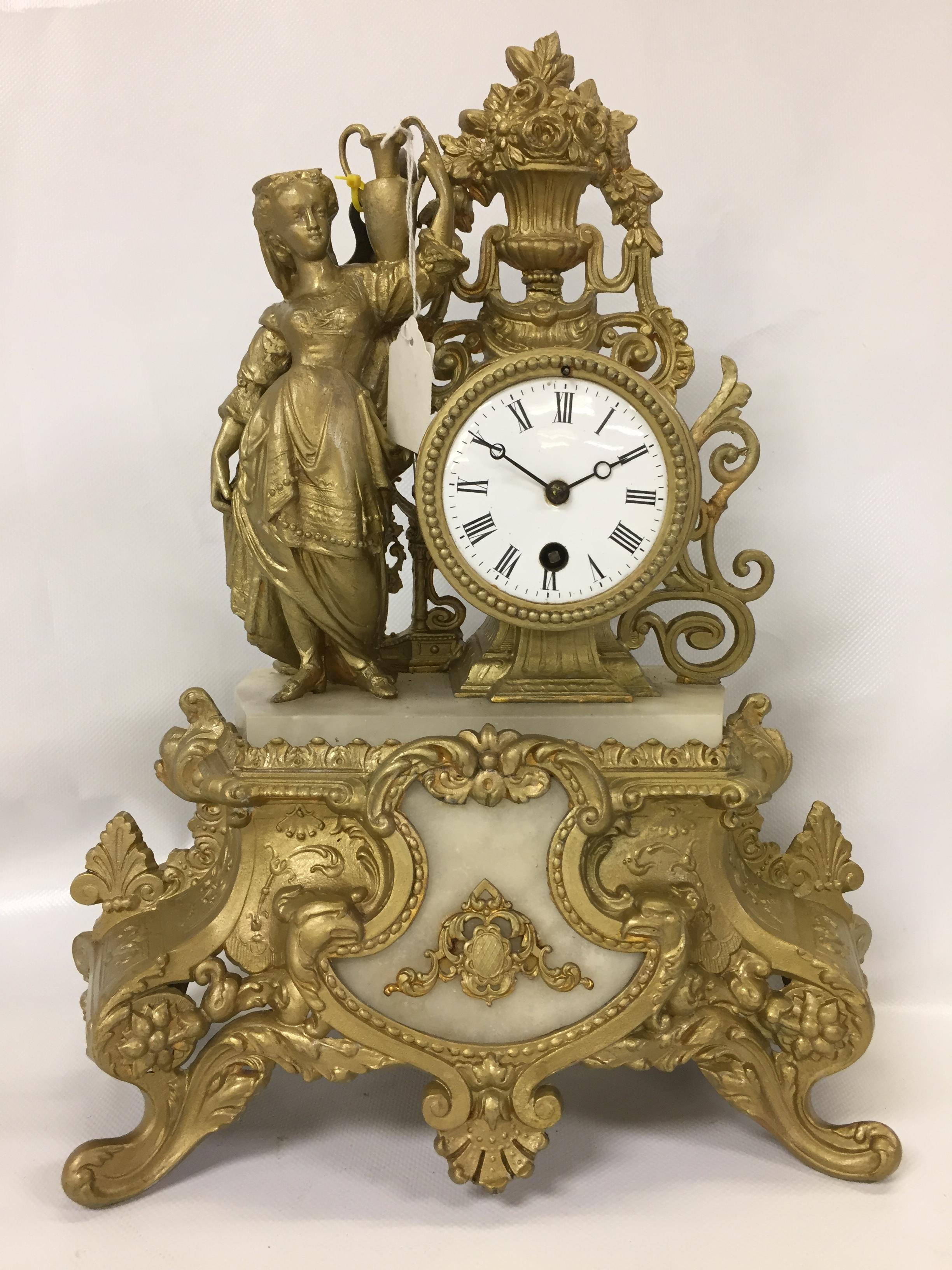 FRENCH CAST CLOCK DECORATED WITH FEMALE WATER CARRIER AND VASE OF FLOWERS,