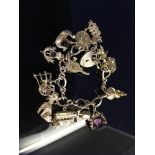 9CT. GOLD CHARM BRACELET WITH 13 GOLD CHARMS (APPROX.