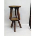 A PAIR OF ELM THREE LEGGED MILKING STOOLS