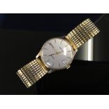 9CT. GOLD GARRARD GENTS QUARTZ WRIST WATCH ON YELLOW METAL BRACELET