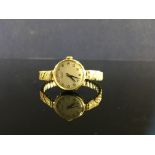 9CT. GOLD TISSOT LADIES WRIST WATCH ON PLATED EXPANDABLE BRACELET