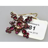 A 19th century cruciform garnet brooch/pendant, the mixed cut stones in closed back setting