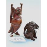 A Japanese late 19th carved hardwood okimono of a Macaque Monkey, with large fruit in hand, 5.5cm