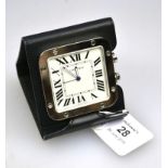 A stainless steel Cartier 'Santos' travel clock, with leather folding stand, in presentation box