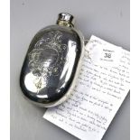 A late Victorian Britannia metal hip flask, oval with screw-off cover and engraved cartouches to