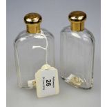 A pair of 20th century 9ct gold topped cologne bottles, of panel cut form, London 1951, 11.5cm high