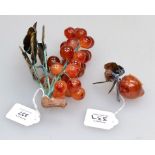 A Chinese carved agate bunch of grapes, with carved marble leaves on silk bound bunch of grapes,