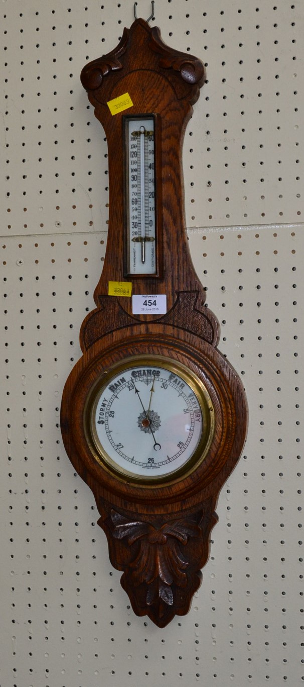 An Edwardian carved oak barometer/thermometer, 65cm
