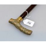 An early 20th century bronze handled gentleman's walking cane, with mahogany shaft, the 'T' handle