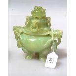 A Chinese 20th century carved celadon jade tripod censer, with dragon mounted cover and captive ring