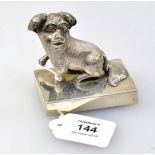 A Chinese silver paper weight, modelled as a dog, the cast canine figure of 'Poor Pat' on