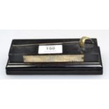Garrard and Co. Ltd, a miniature silver presentation sabre, on an ebonised wood plinth, with