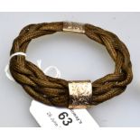An early 19th century rose gold mounted plaited hair bracelet, the multi-strand braided hair