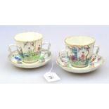 A pair of Qain Long, famille rose trembleuse twin handled cups and saucers, each decorated with