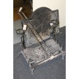 A collection of hearth items, including arched fire back, pot holder, fire dogs, grate and