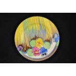 A Clarice Cliff Delicia Pansy pattern plate, marked Bizarre to base - diam 22.