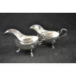 A pair of late Victorian silver sauceboats on shell and hoof feet, Sheffield 1898,