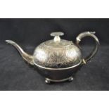 An early 19th century silver teapot of spherical shape, acanthus leaf to scroll handle,