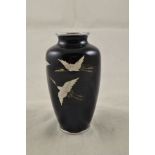 A Japanese cloisonne ginbari vase by Ando, black ground decorated with flight of three cranes,