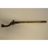 A 19th century Afghan Jezail muzzle loading flintlock musket, carved walnut stock, 73cm barrel,