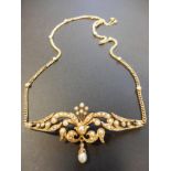 A Victorian 15ct gold three section pendant mounted with seed pearls in foliate setting,