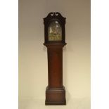 An 18th century scumbled pine longcase clock with arched pediment,