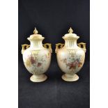 A pair of Royal Worcester blush ivory floral painted two handled vases and covers,