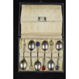 A cased set of six silver coffee spoons by Liberty & Co, with semi-precious stone 'bean' terminals,