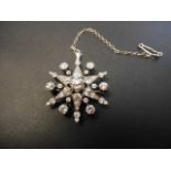 A Victorian white metal star brooch/pendant set with a total of forty three diamonds,