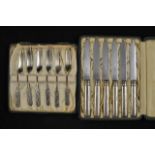 A set of six cased Liberty dessert knives with hammered silver handles marked L&Co, Birmingham 1929,