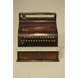 An early 20th century National cash register with mahogany woodgrained metal case, no.