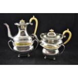 An early 20th century four piece silver tea set comprising teapot, hot water jug,