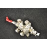 A silver teething rattle/whistle with coral to end,