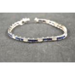 An 18ct white gold tennis bracelet set with twenty-four square cut diamonds and forty-six square